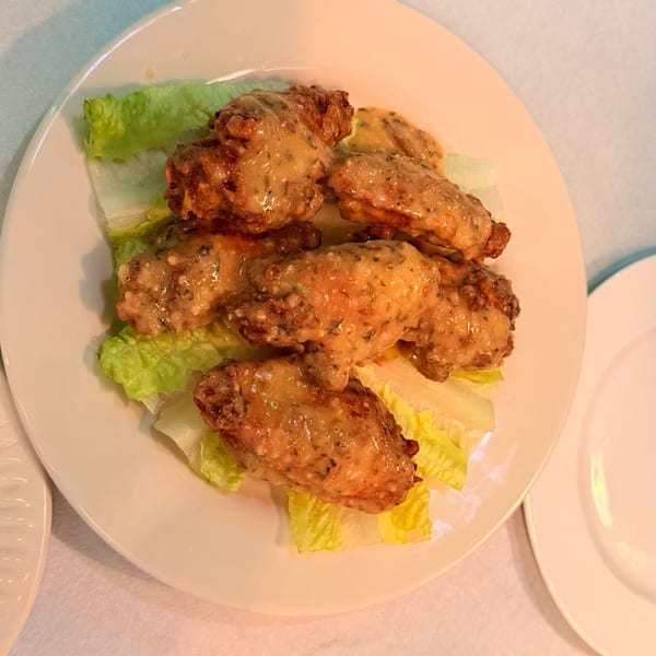 Garlic parmesan wings over crisp romaine.
