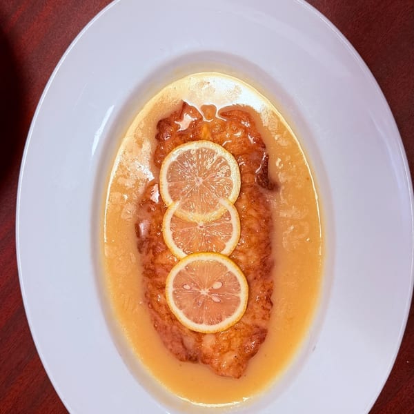 Chicken Française with lemon in a delicate butter sauce.