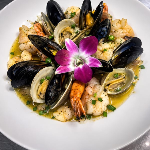 Seafood linguine with shrimp, mussels, and clams in white wine sauce.