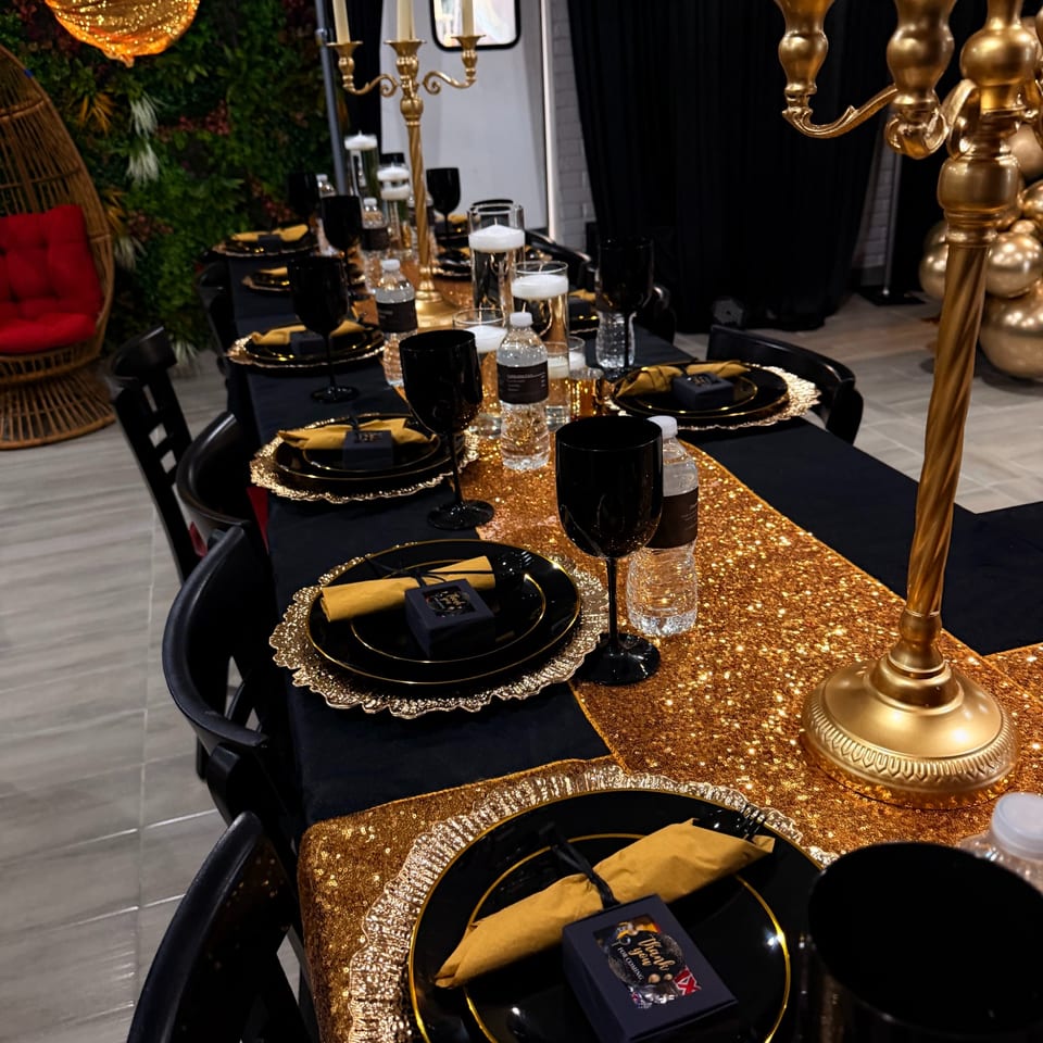 Black and gold table setting for a private event