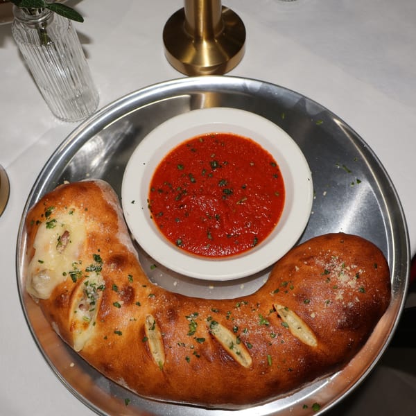 Stromboli with a side of marinara dipping sauce.